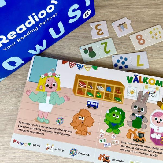 Uppslag ur Prinsessan på besök som visar färgglada illustrationer och dialoger