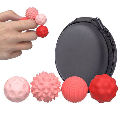Hand håller rosa och röda sensoriska magnetkulor för avslappning. 